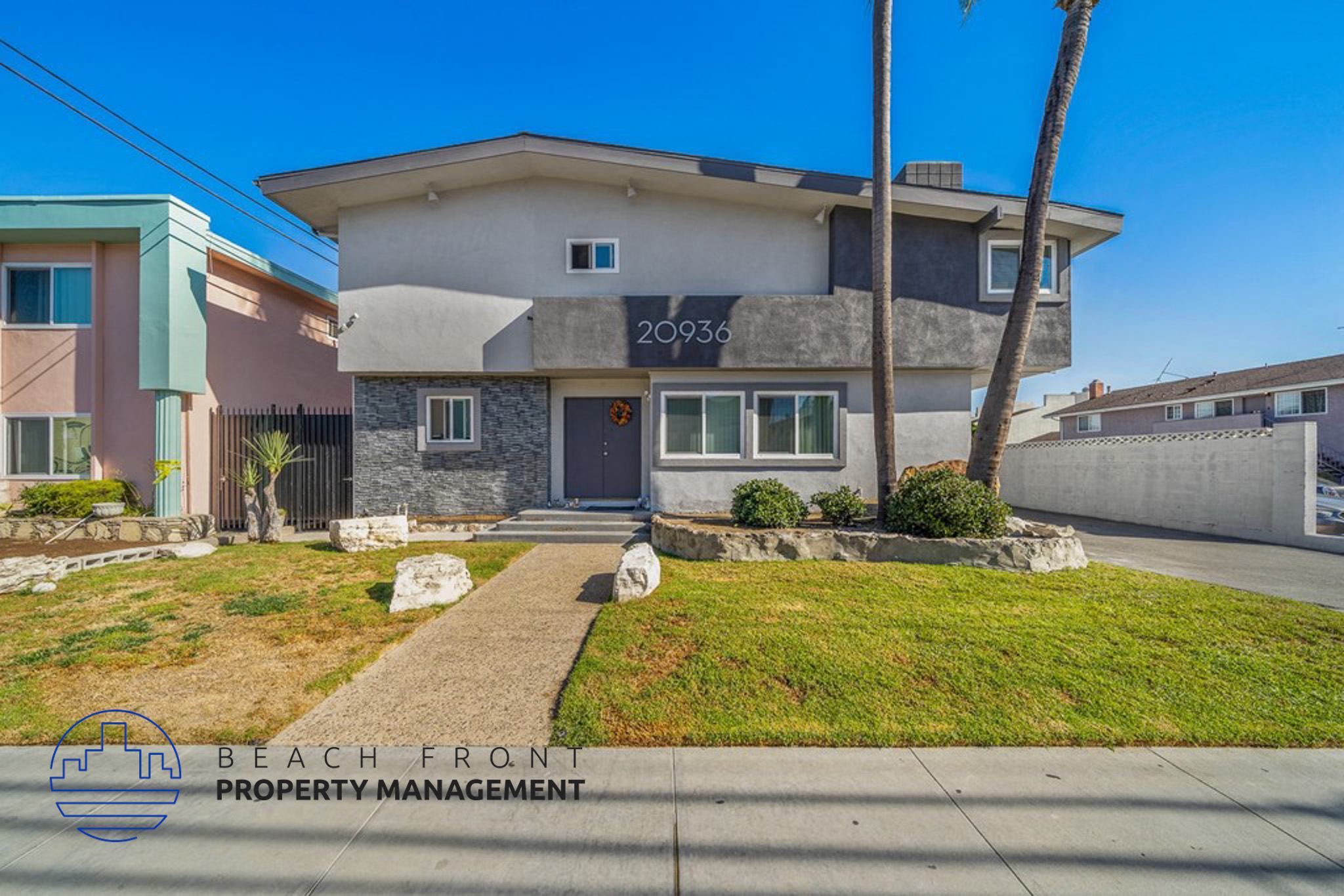 a home with a sidewalk and grass in front of it